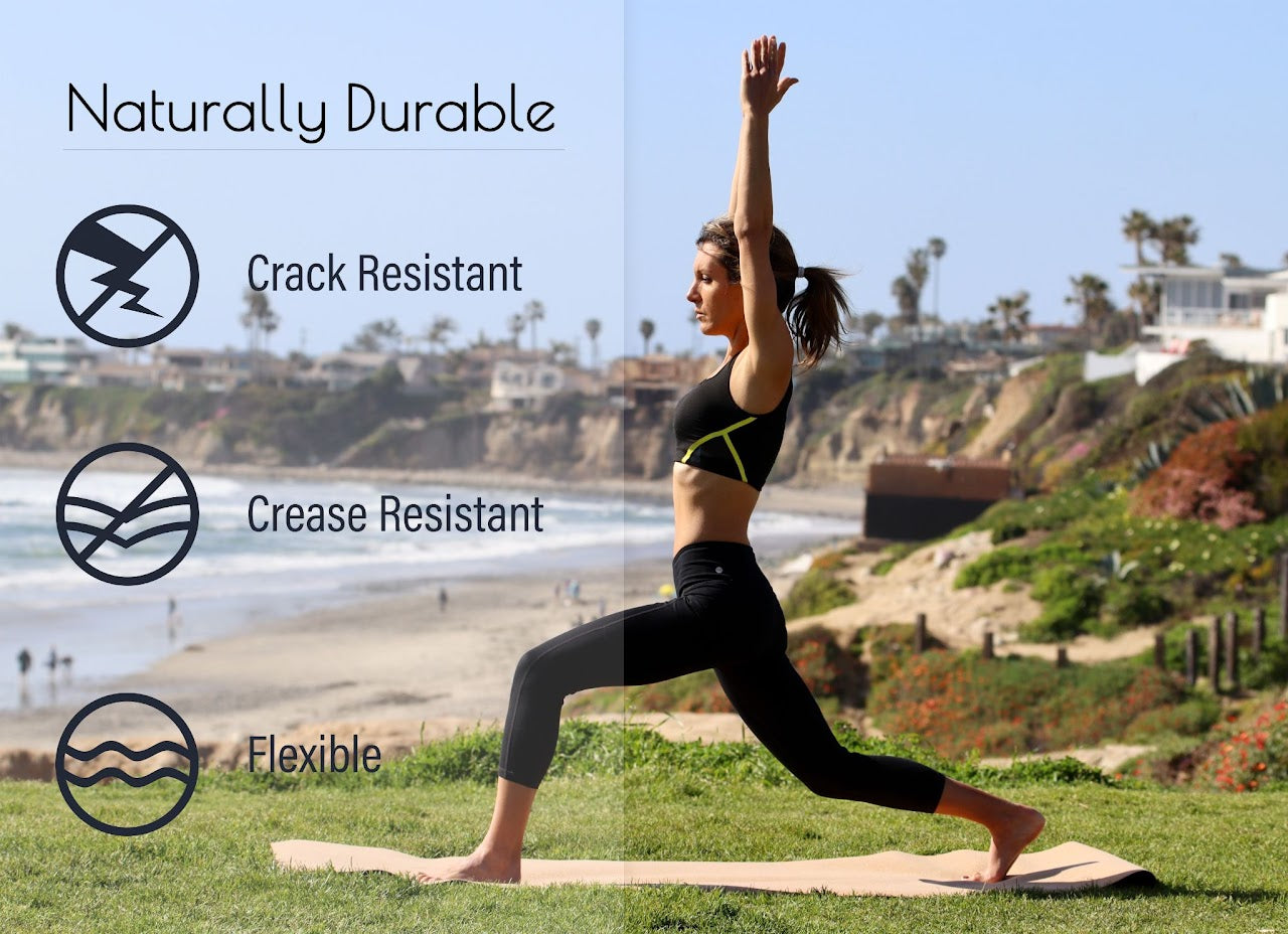 Lightweight travel cork yoga mat rolled out on the sand for beach yoga