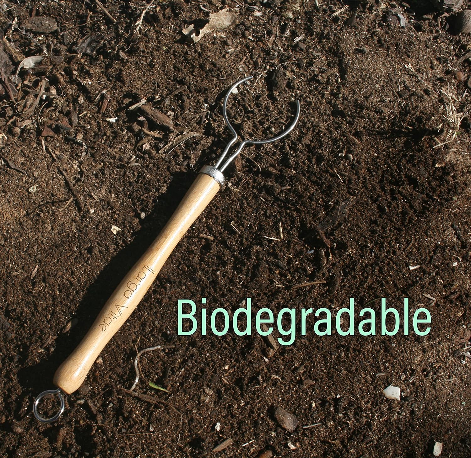 thin biodegradable bamboo dish brush wooden handle on soil
