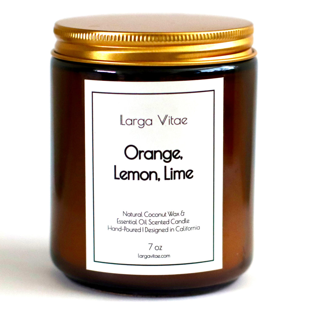 Larga Vitae's Orange, Lemon, Lime allergy friendly naturally scented candle jar with gold lid on a white background
